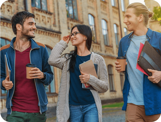 Three friends walking, holding coffees and notebooks.